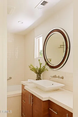 a bathroom with a sink and a mirror