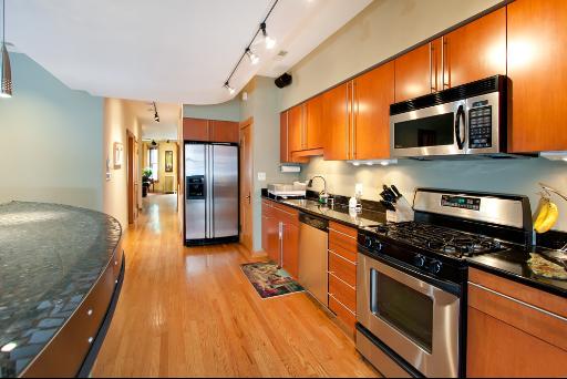 3638 North Fremont Street Chicago, IL 60613 - Photo 4 of 10 a kitchen with stainless steel appliances granite countertop a stove a sink and a refrigerator
