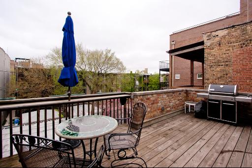 3638 North Fremont Street Chicago, IL 60613 - Photo 9 of 10 a view of a balcony with furniture and wooden floor