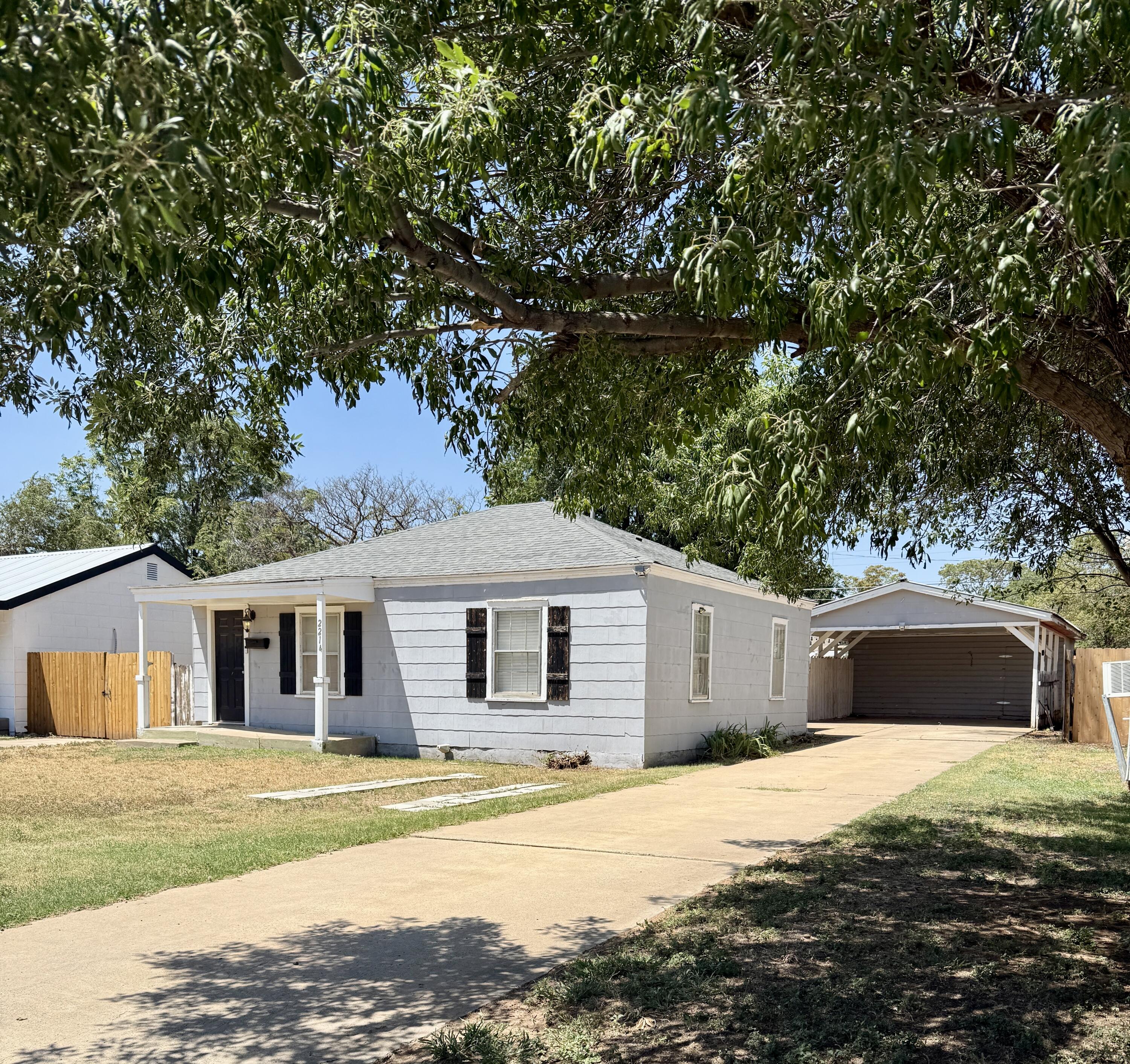 2214 40th Street Lubbock, TX 79412 - Photo 1 of 58 a front view of a house with a yard