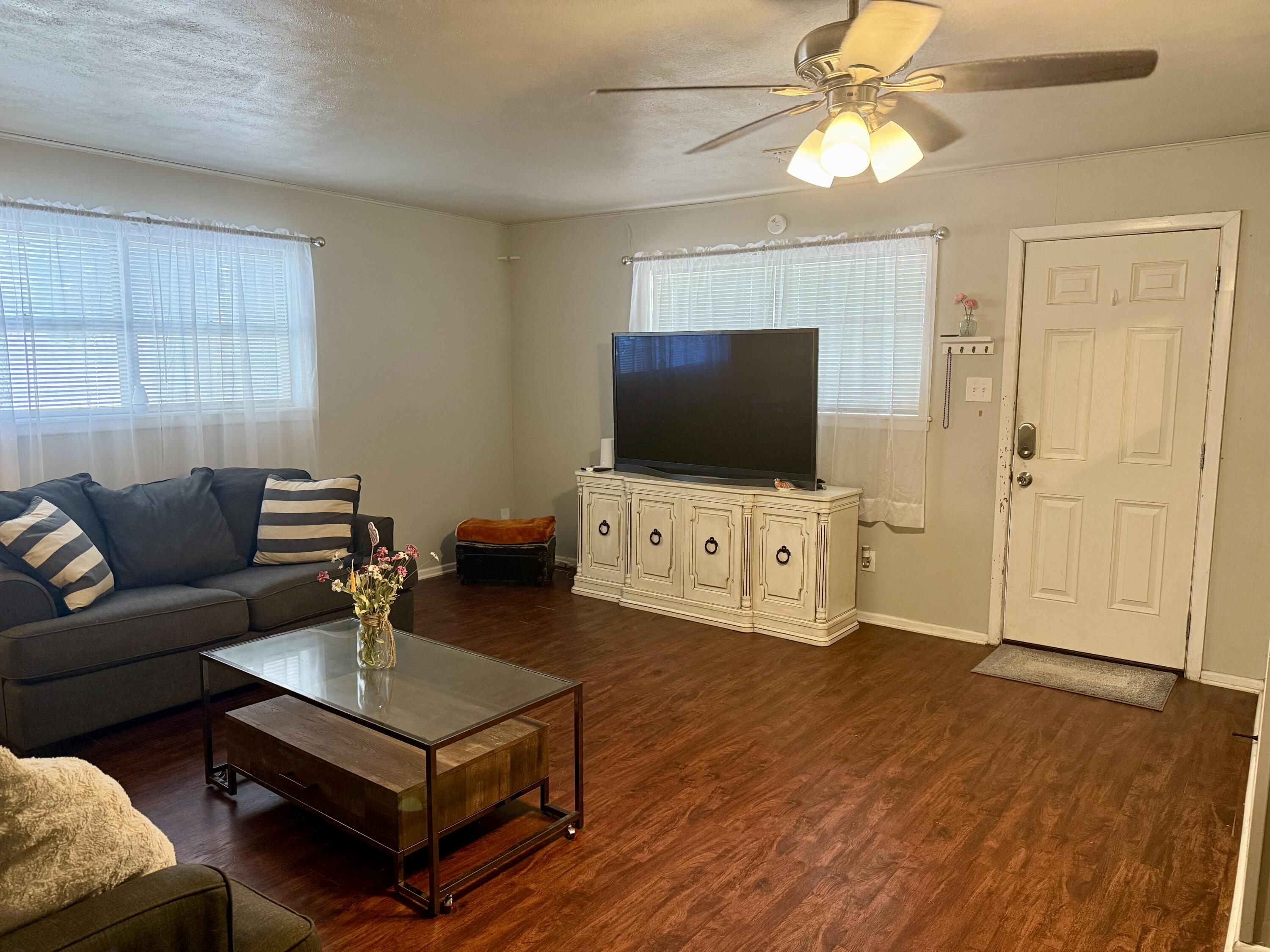 2214 40th Street Lubbock, TX 79412 - Photo 12 of 58 a living room with furniture and a flat screen tv