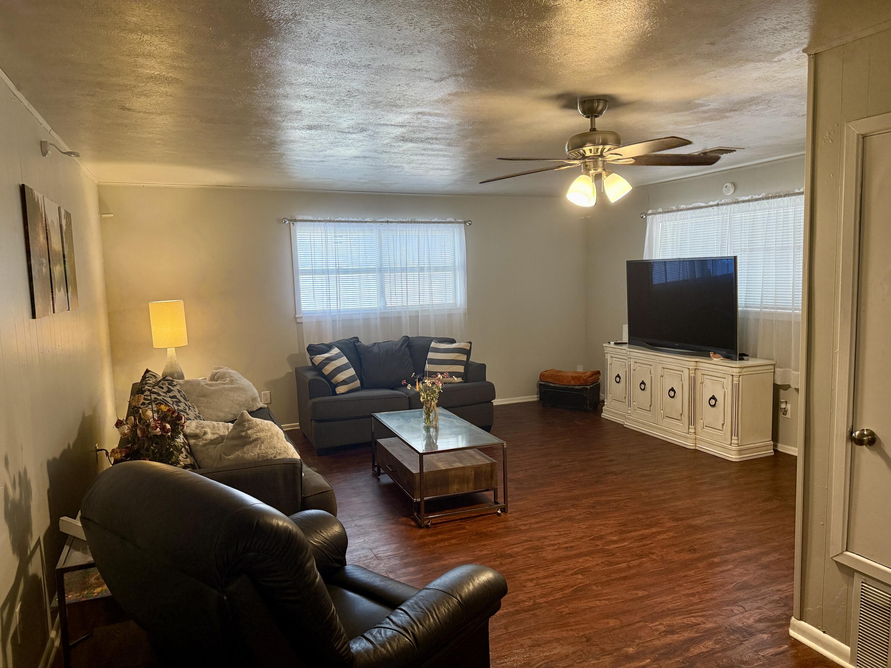 2214 40th Street Lubbock, TX 79412 - Photo 13 of 58 a living room with furniture and a flat screen tv