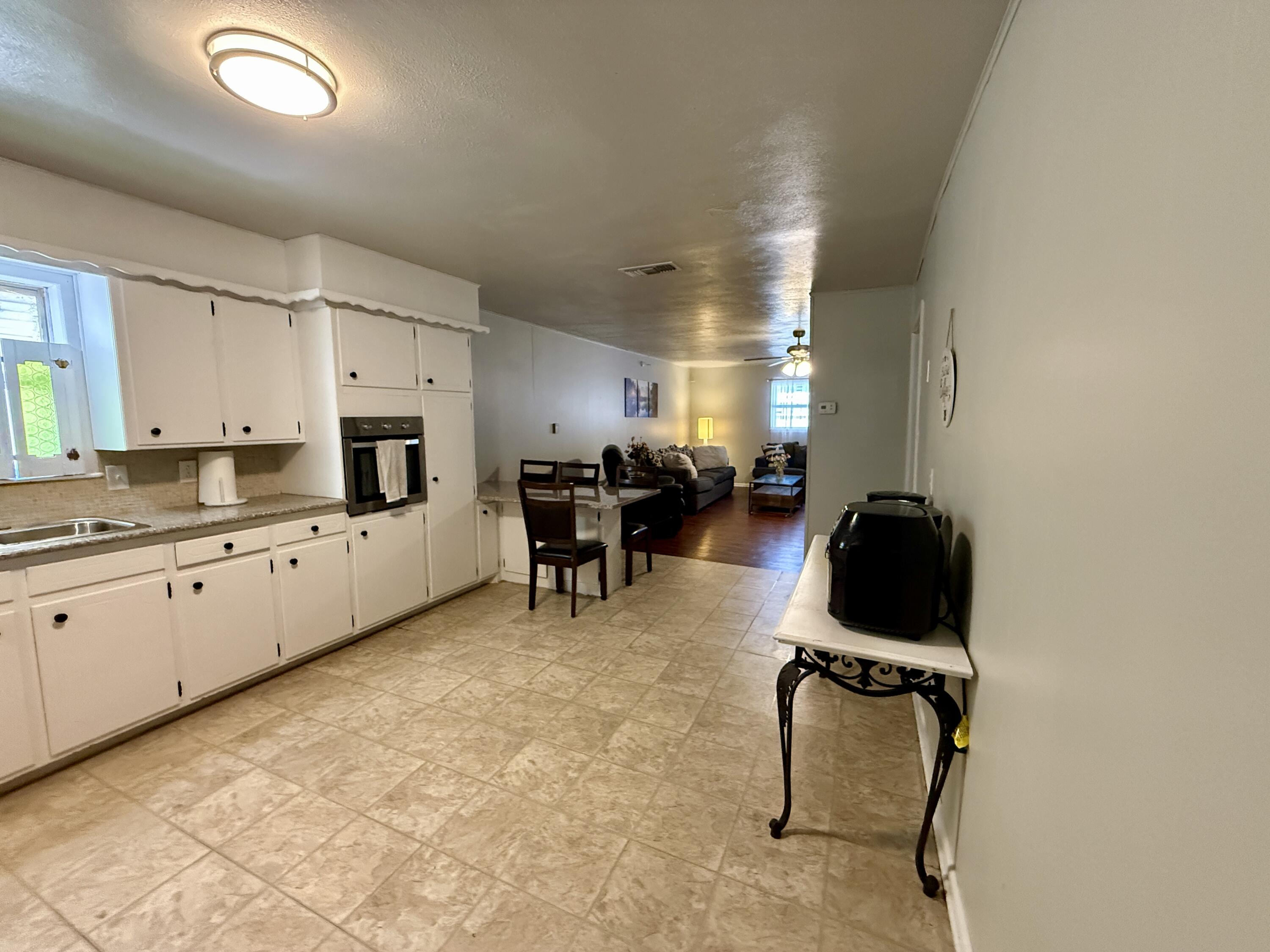 2214 40th Street Lubbock, TX 79412 - Photo 18 of 58 a kitchen with furniture and kitchen view