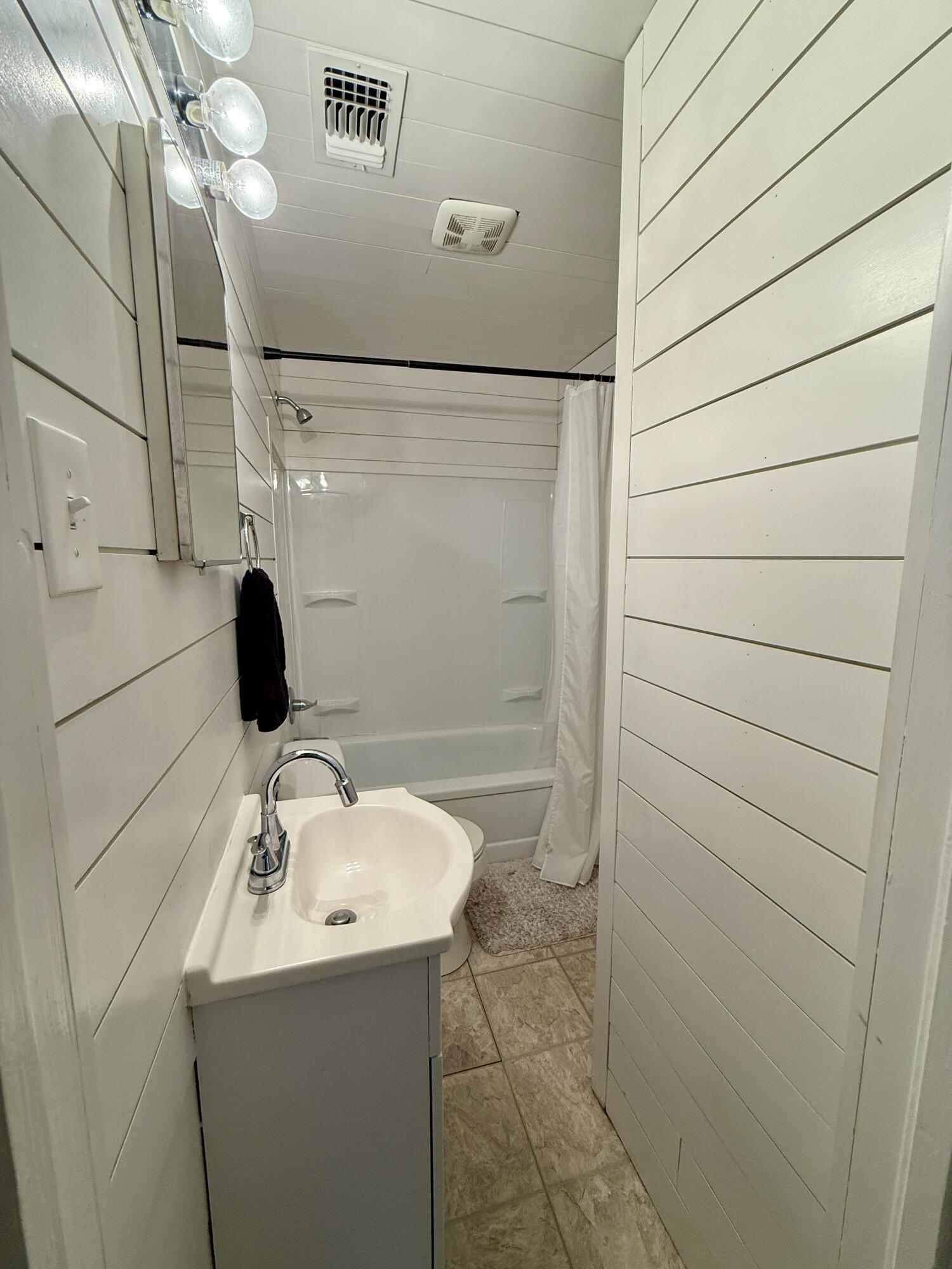 2214 40th Street Lubbock, TX 79412 - Photo 27 of 58 a bathroom with a sink and shower