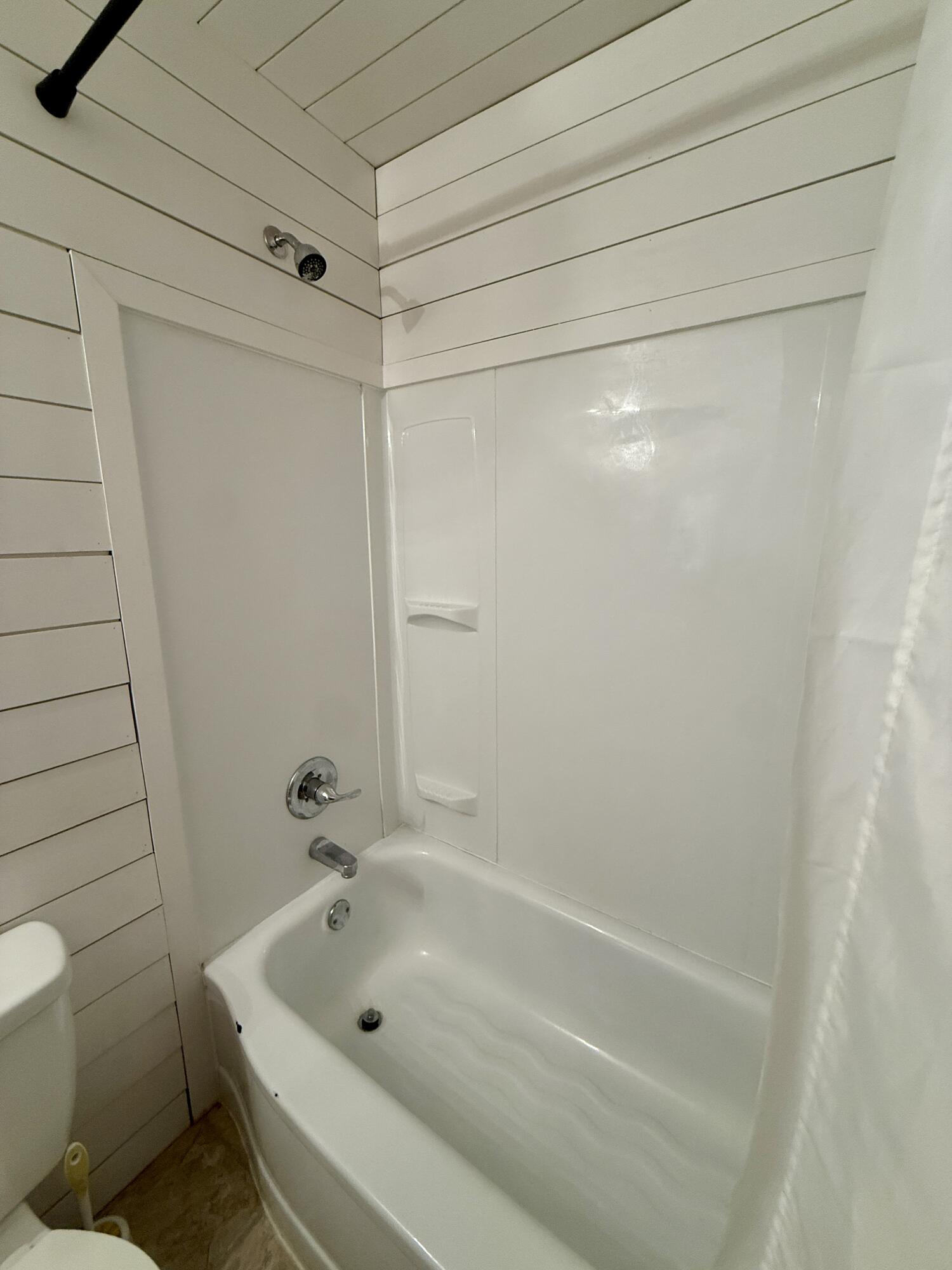 2214 40th Street Lubbock, TX 79412 - Photo 28 of 58 a bathroom with a tub and a shower