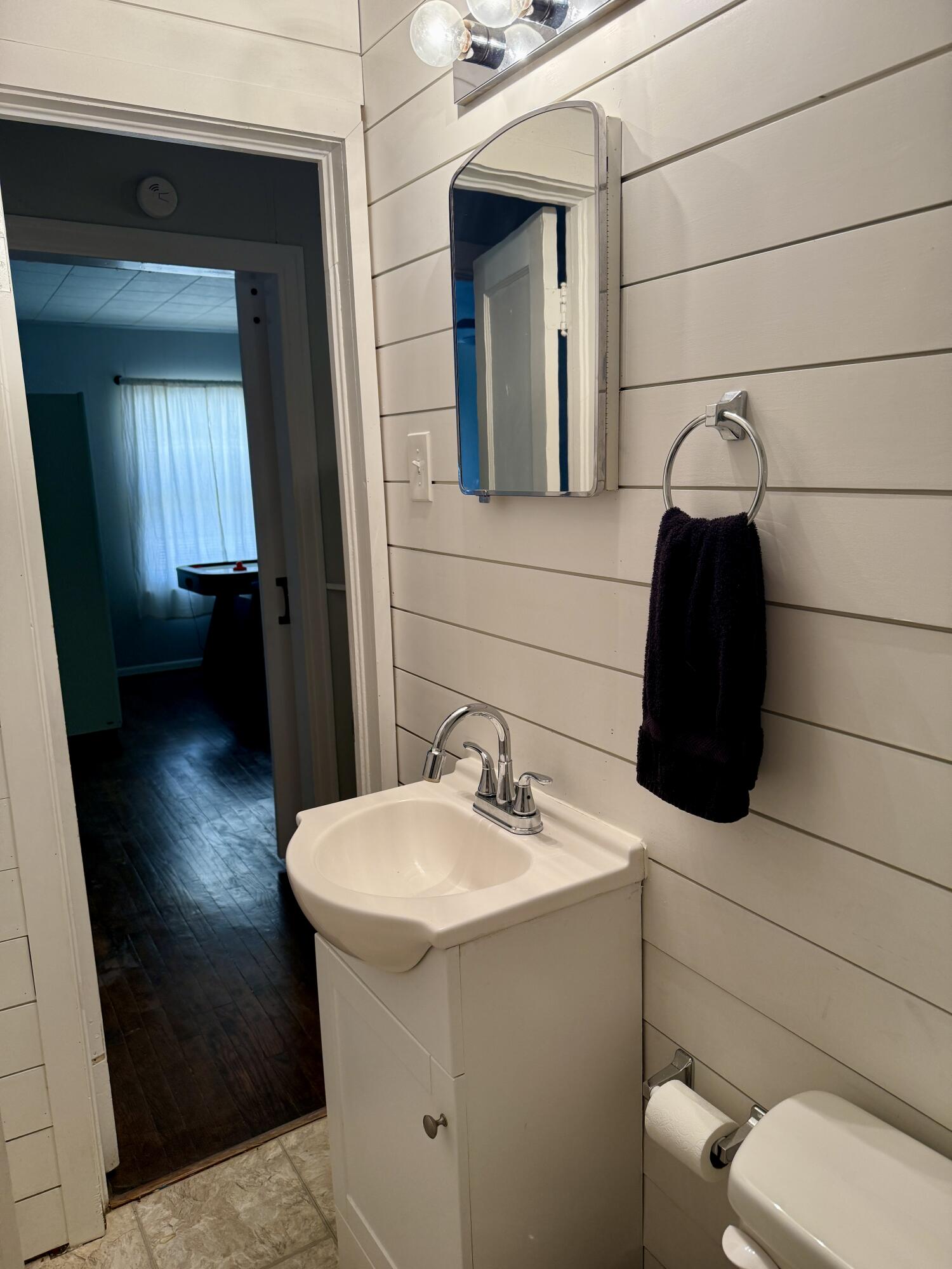 2214 40th Street Lubbock, TX 79412 - Photo 29 of 58 a bathroom with a sink toilet and mirror