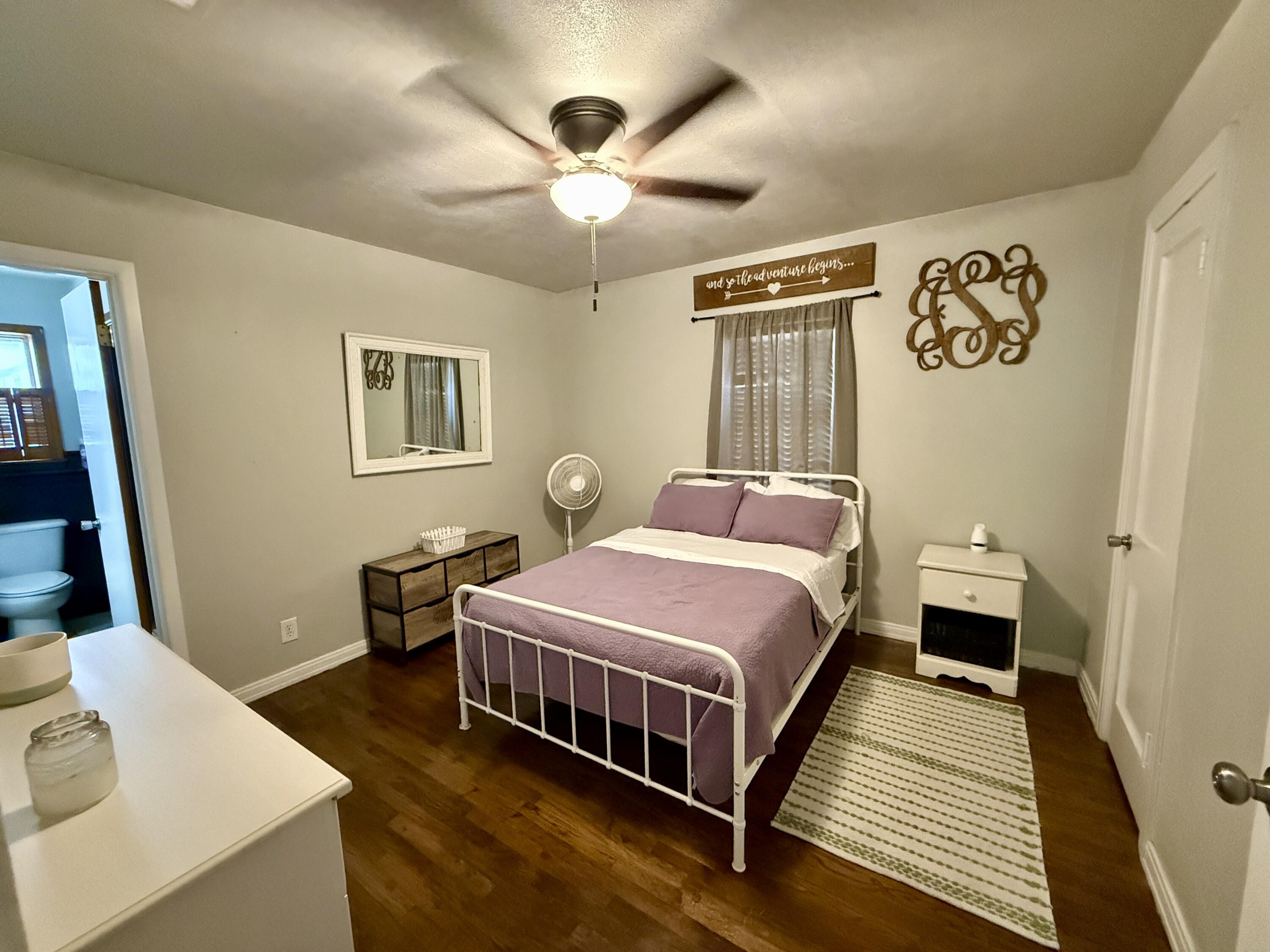 2214 40th Street Lubbock, TX 79412 - Photo 30 of 58 a bed room with a bed and a chandelier