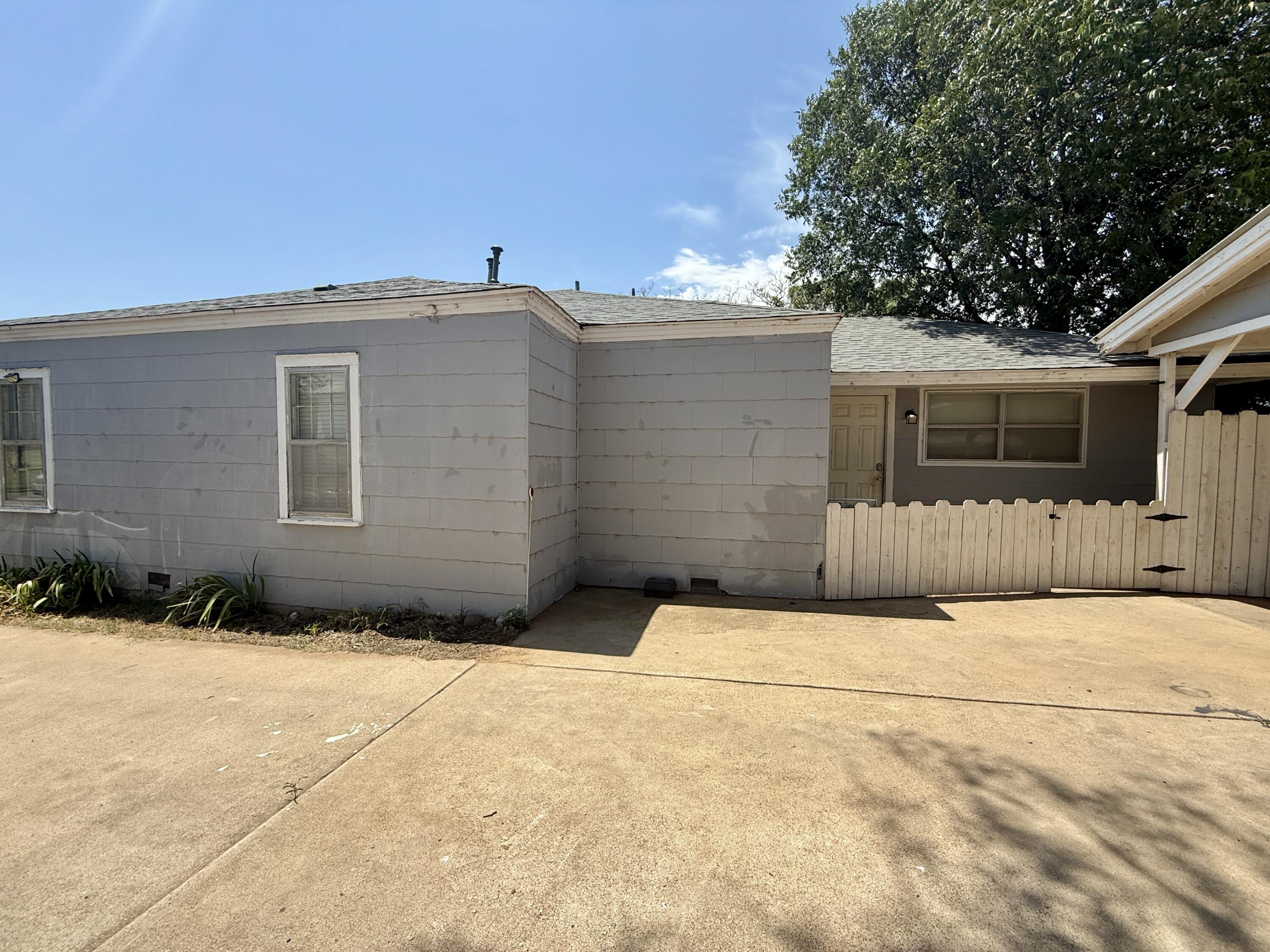 2214 40th Street Lubbock, TX 79412 - Photo 3 of 58 a backyard of a house with garage and trees