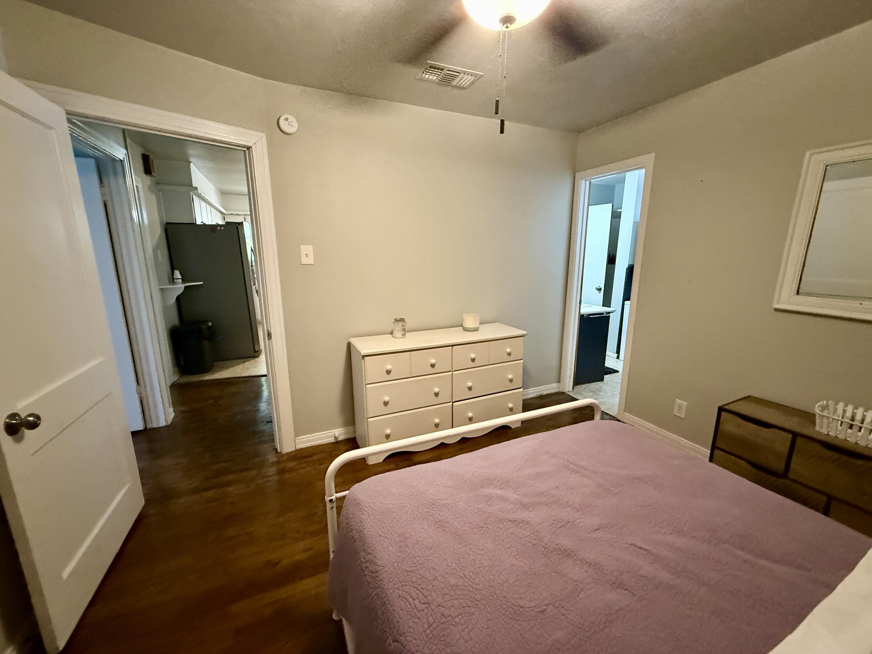 2214 40th Street Lubbock, TX 79412 - Photo 31 of 58 a bedroom with a bed and a mirror