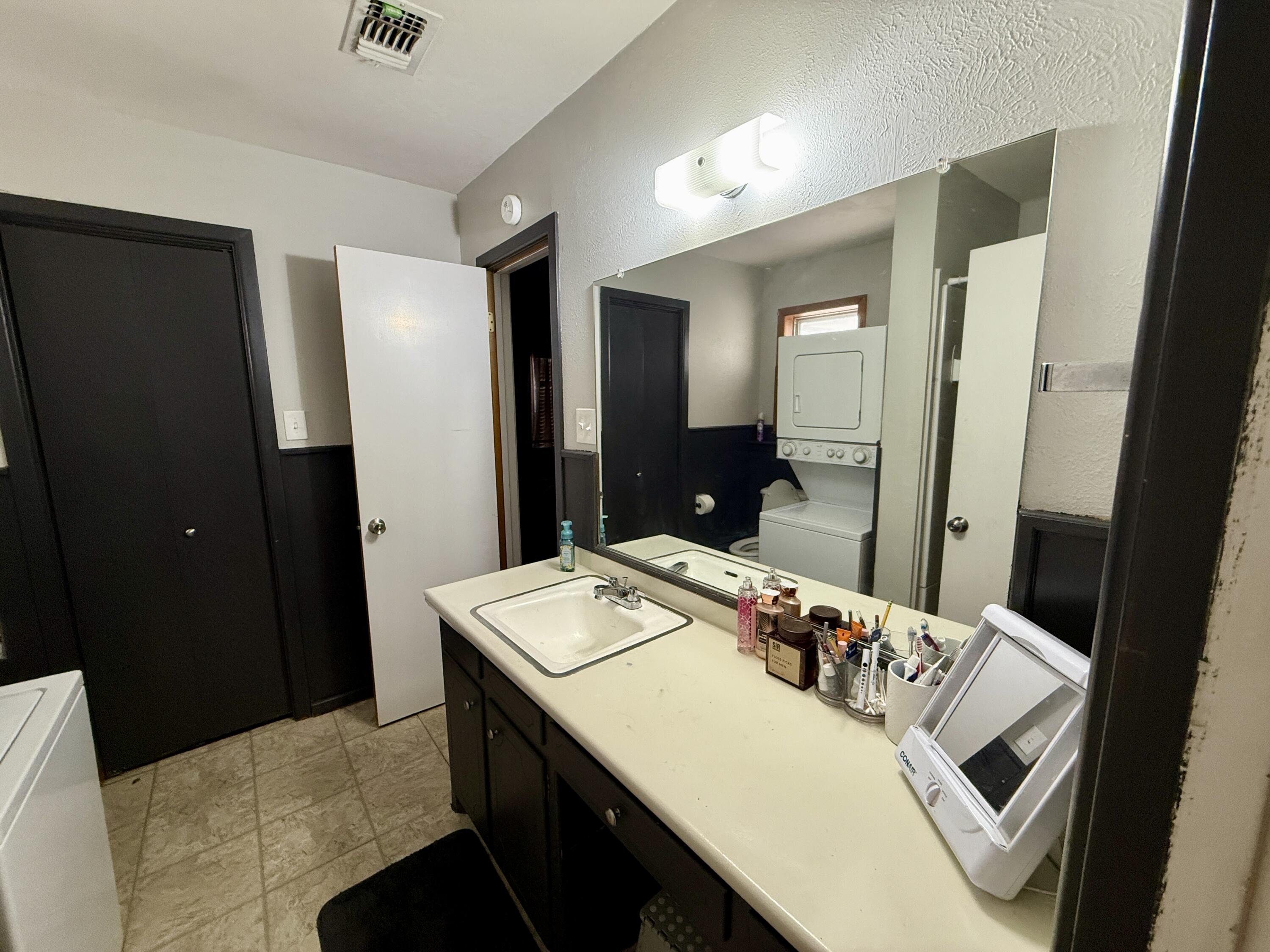 2214 40th Street Lubbock, TX 79412 - Photo 33 of 58 a bathroom with a sink and a mirror