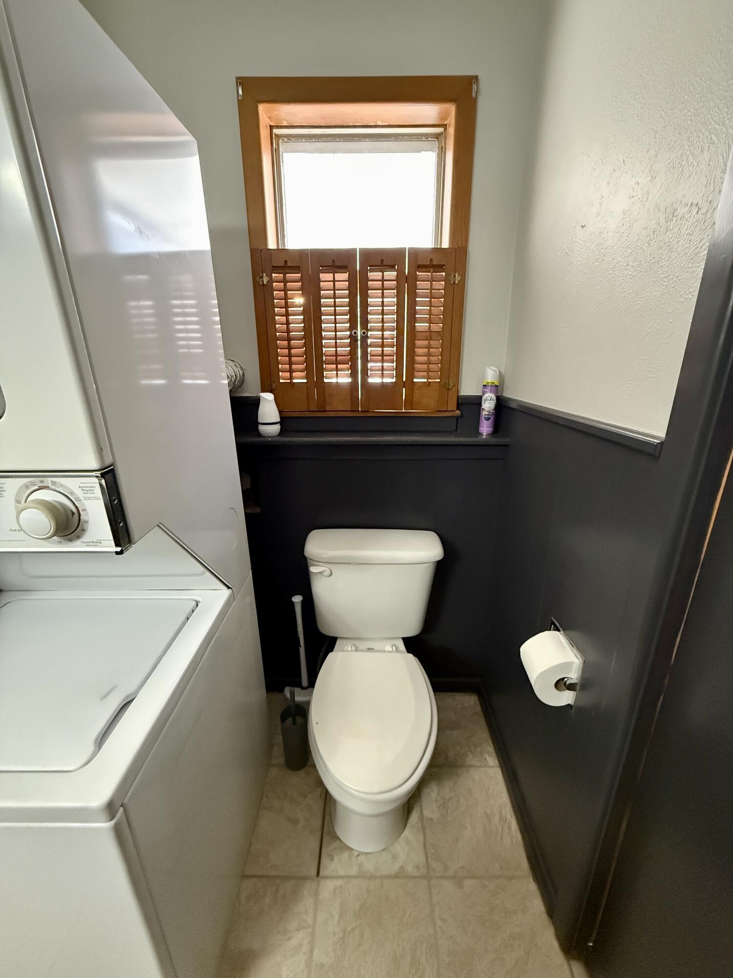 2214 40th Street Lubbock, TX 79412 - Photo 36 of 58 a bathroom with a toilet sink and mirror