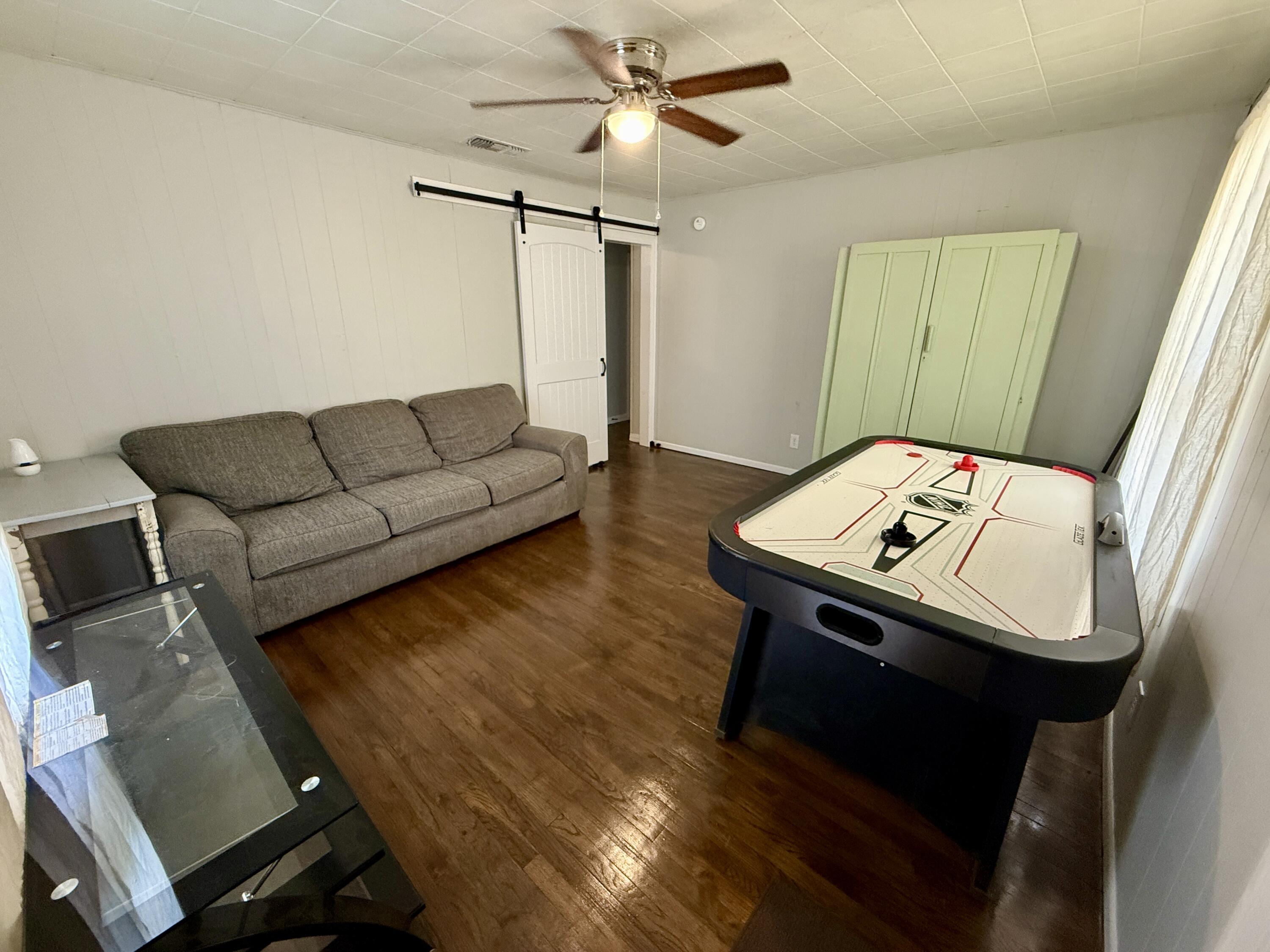 2214 40th Street Lubbock, TX 79412 - Photo 44 of 58 a living room with furniture and a chandelier