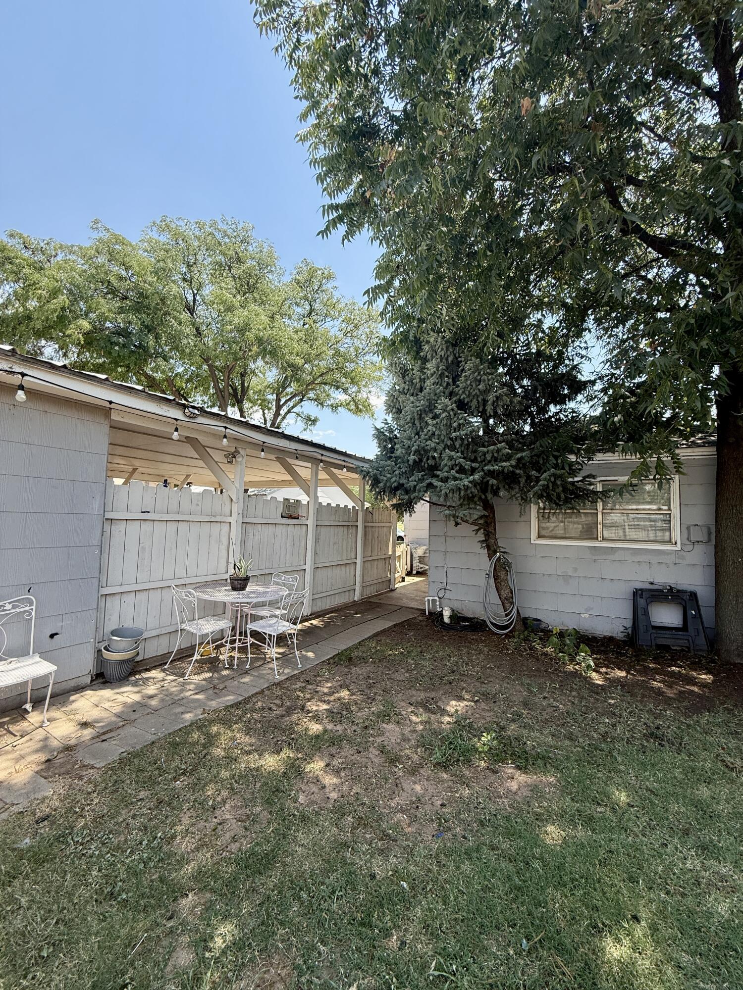 2214 40th Street Lubbock, TX 79412 - Photo 55 of 58 a backyard of a house with table and chairs