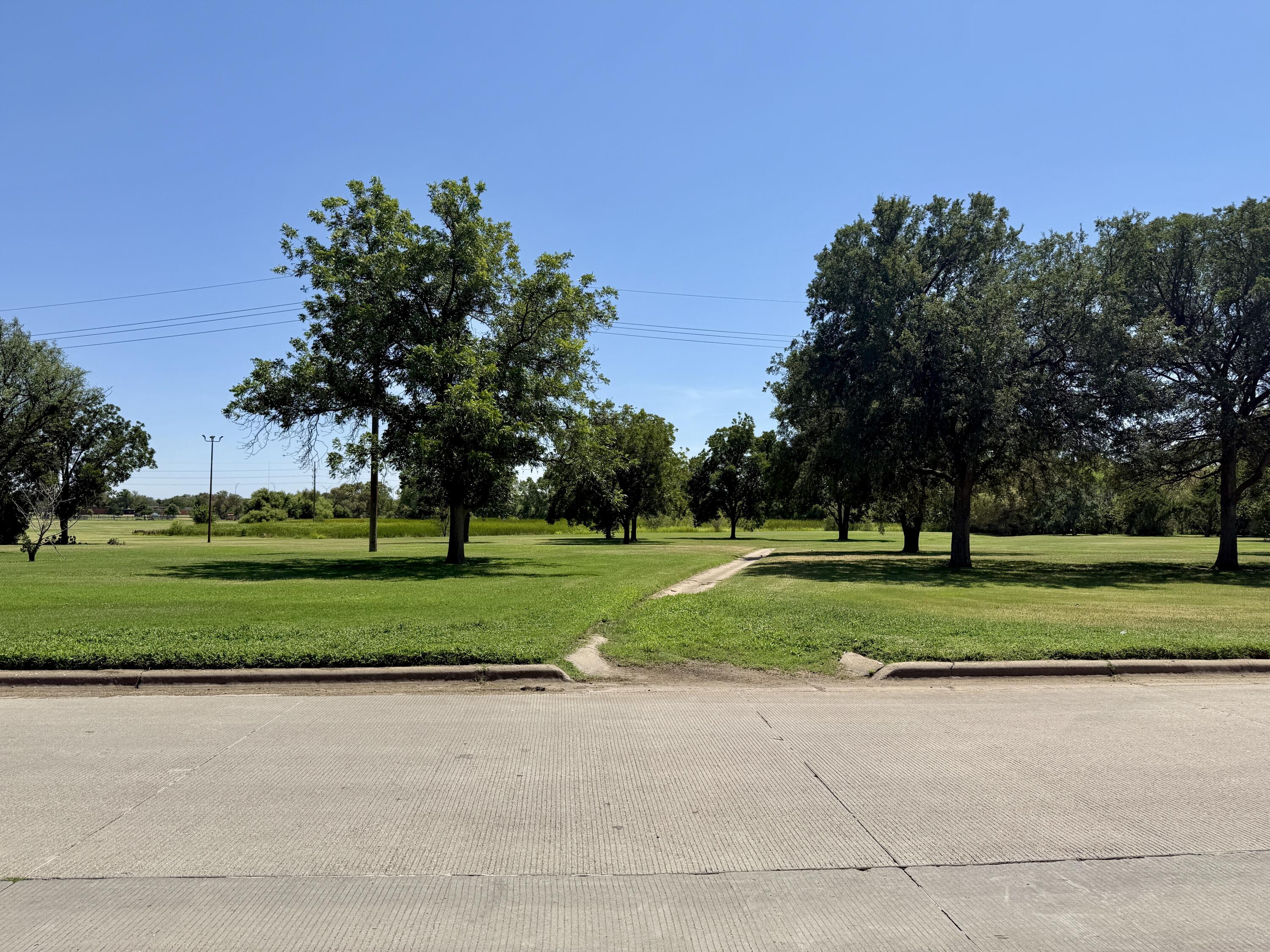 2214 40th Street Lubbock, TX 79412 - Photo 56 of 58 a green field with tree in the background