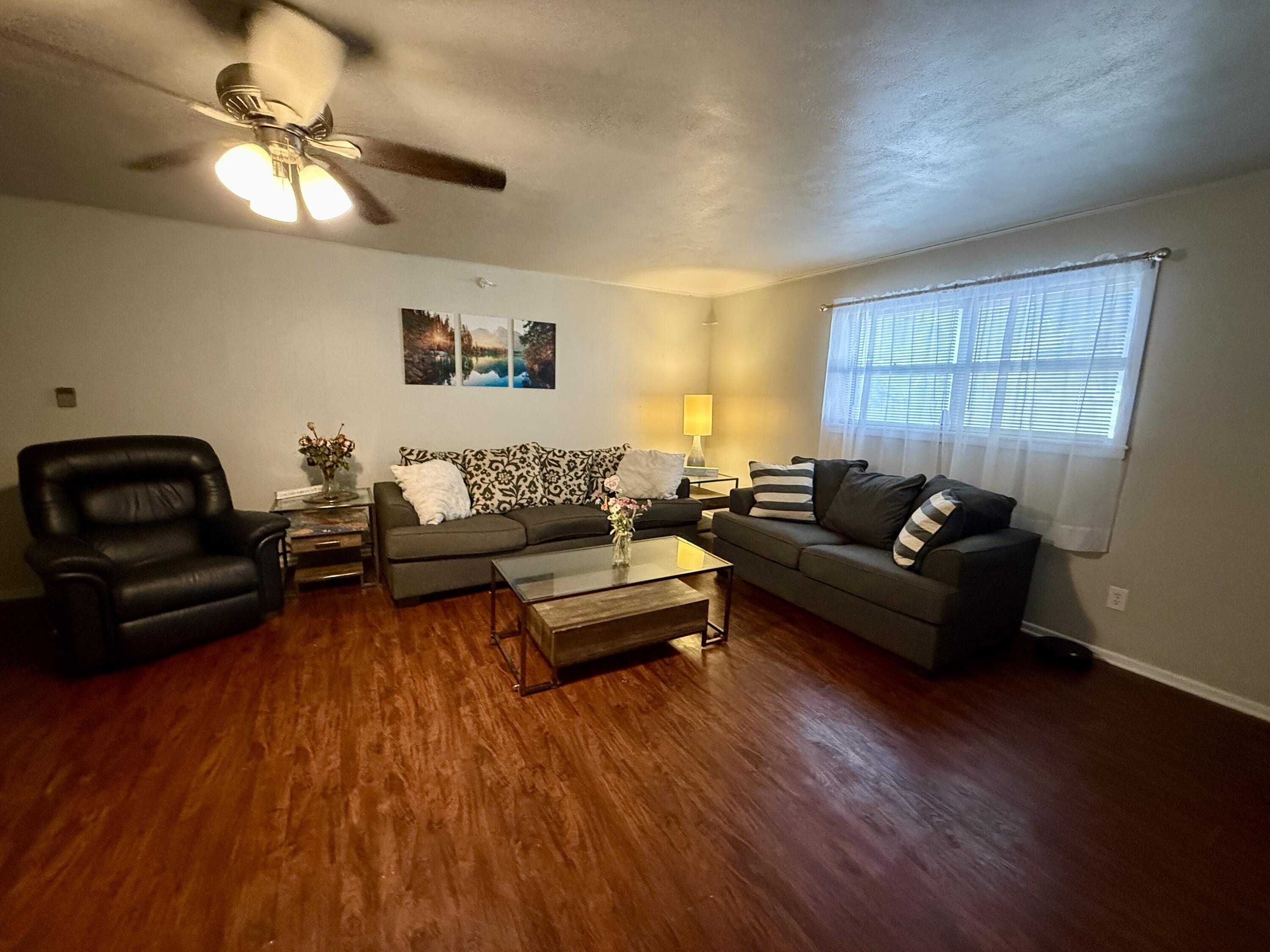 2214 40th Street Lubbock, TX 79412 - Photo 10 of 58 a living room with furniture and a wooden floor