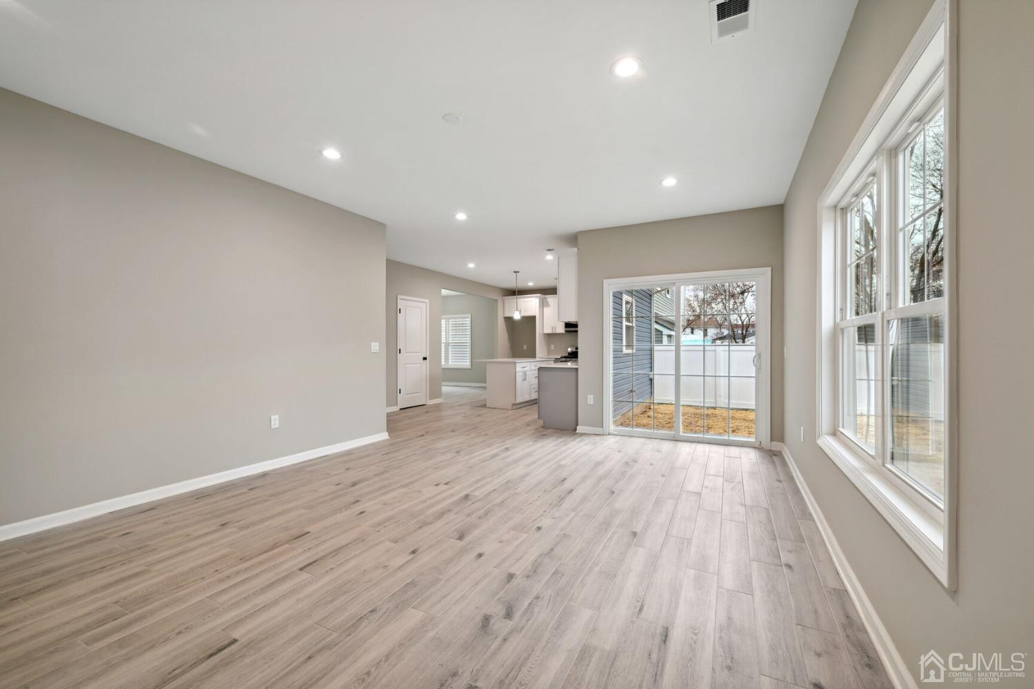 66 Runyon Avenue Edison, NJ 08817 - Photo 12 of 34 a view of an empty room with wooden floor and a window