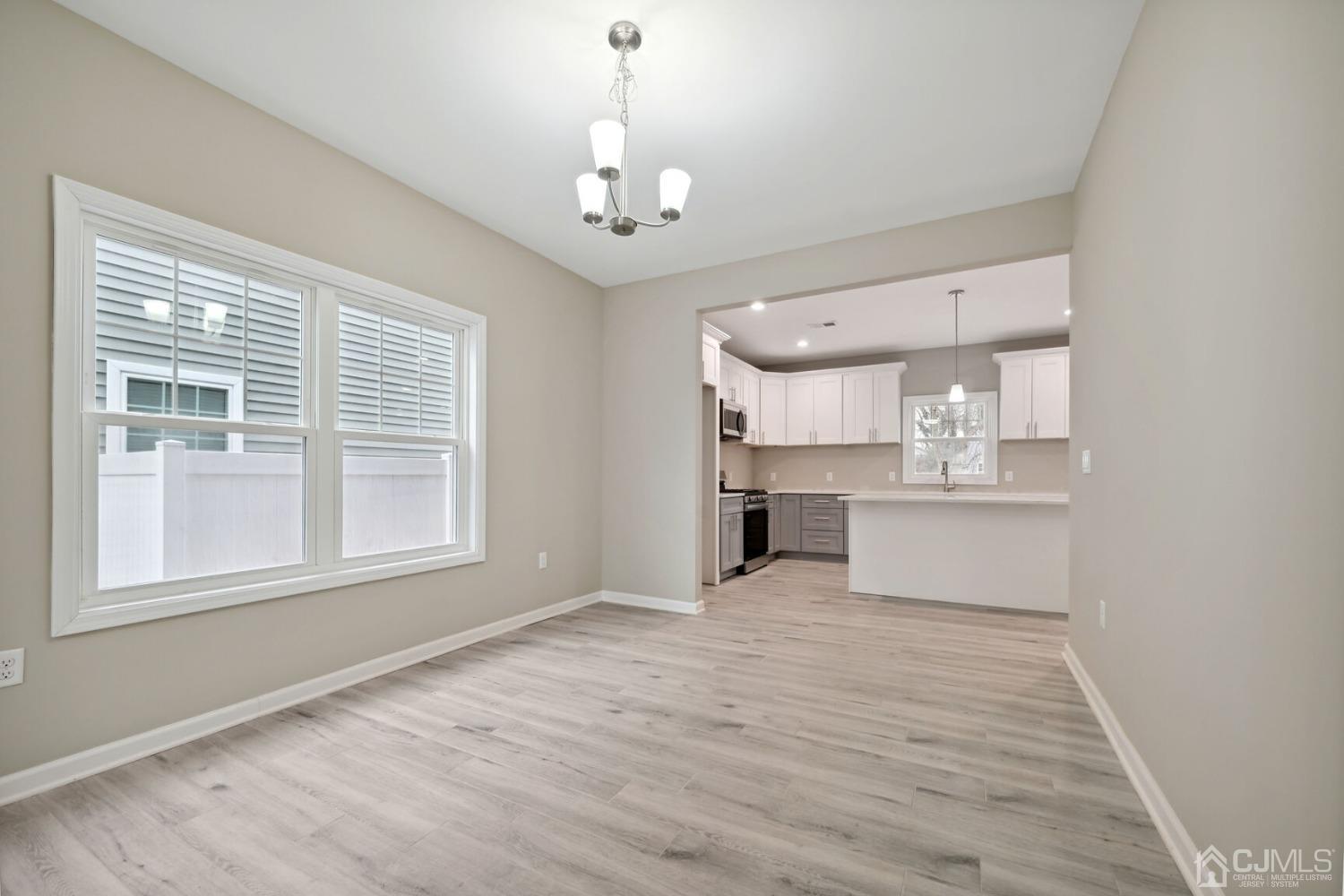 66 Runyon Avenue Edison, NJ 08817 - Photo 13 of 34 a view of an empty room with a kitchen