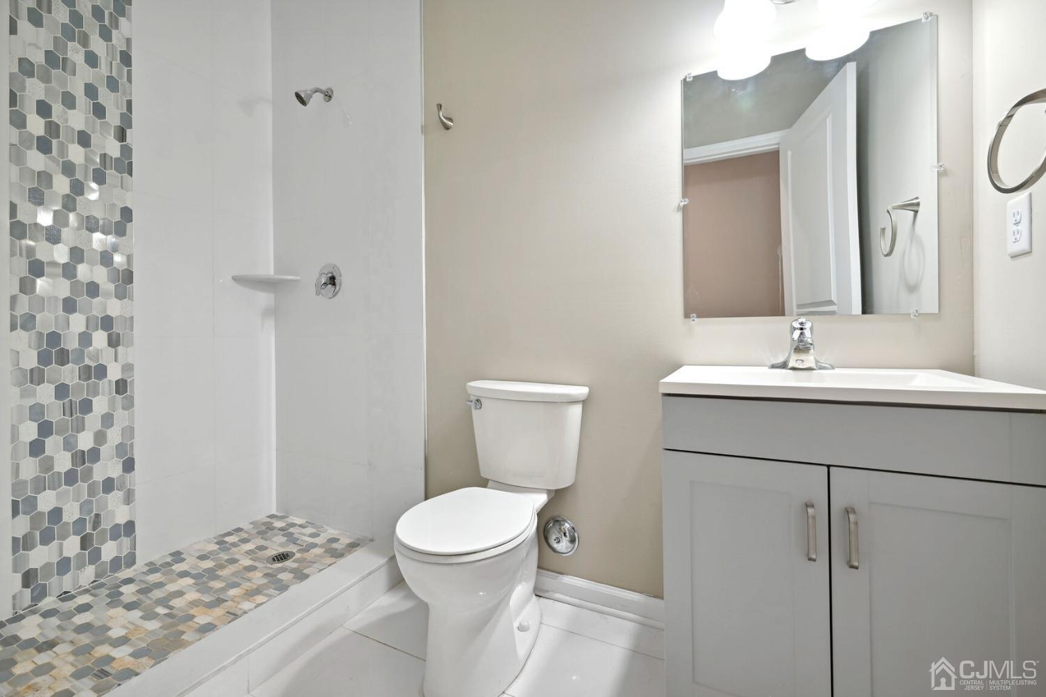 66 Runyon Avenue Edison, NJ 08817 - Photo 18 of 34 a bathroom with a sink a toilet and shower