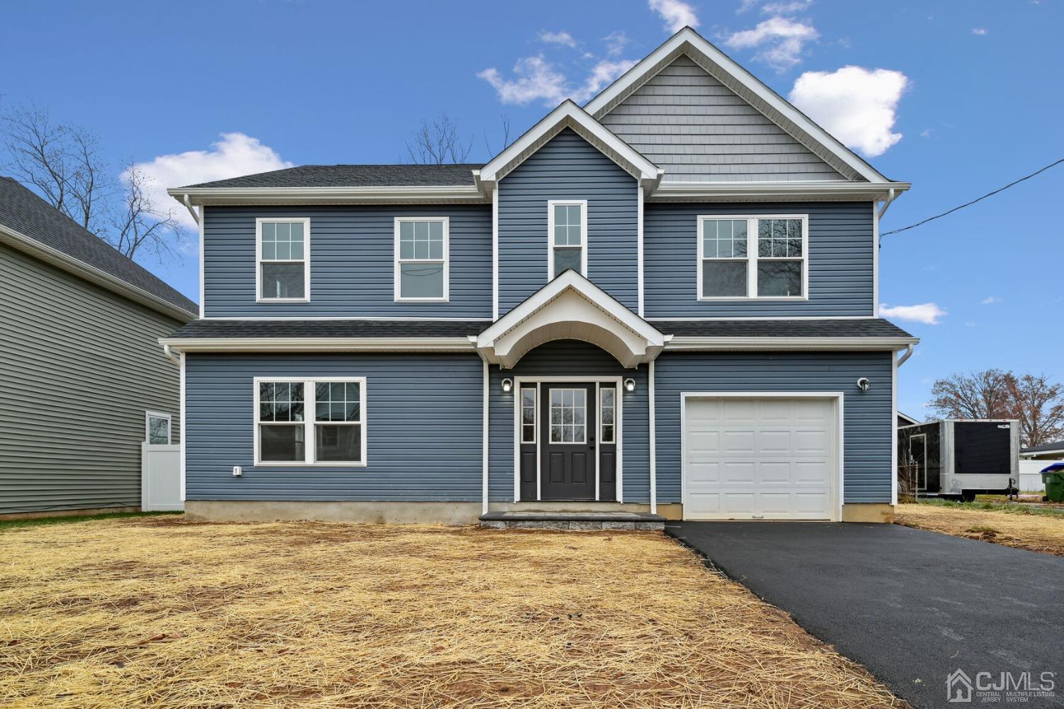 66 Runyon Avenue Edison, NJ 08817 - Photo 2 of 34 a front view of a house with a yard and garage