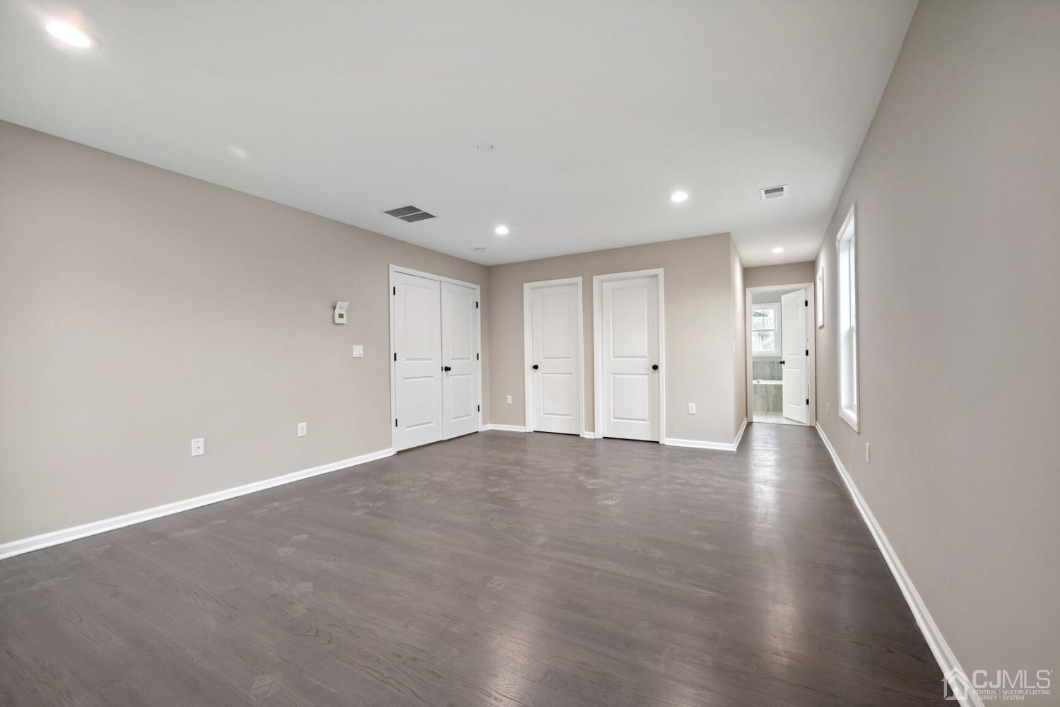 66 Runyon Avenue Edison, NJ 08817 - Photo 26 of 34 a view of an empty room with wooden floor