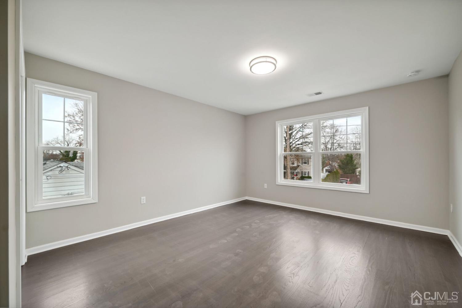 66 Runyon Avenue Edison, NJ 08817 - Photo 27 of 34 an empty room with wooden floor and windows