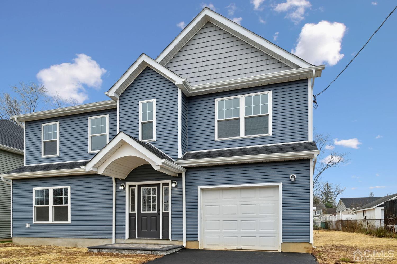 66 Runyon Avenue Edison, NJ 08817 - Photo 3 of 34 a front view of a house with a yard