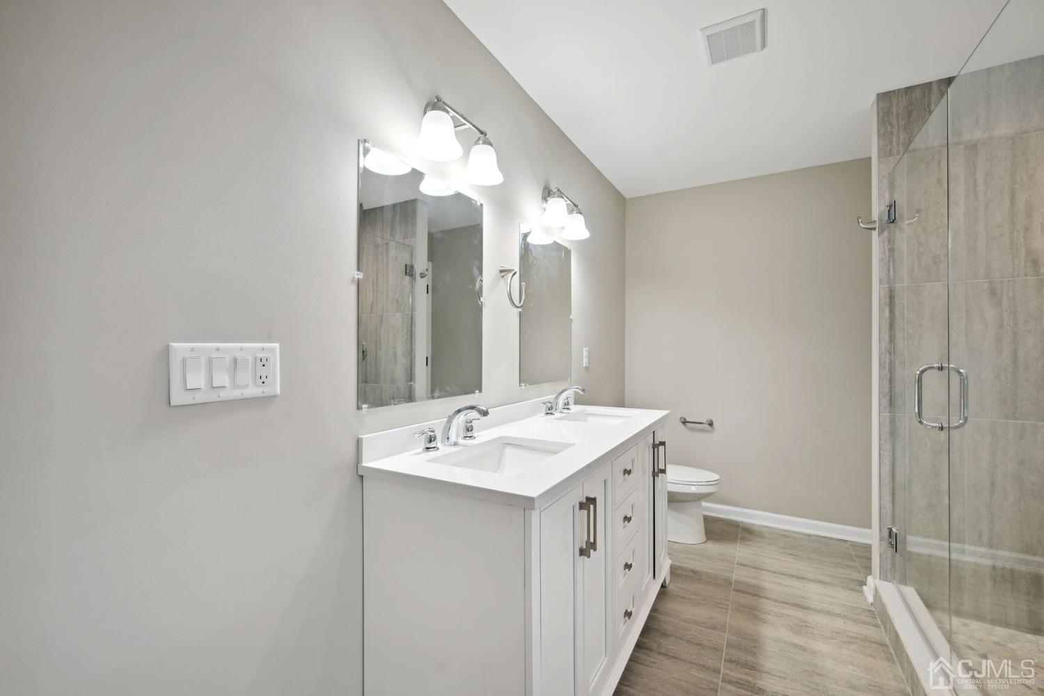 66 Runyon Avenue Edison, NJ 08817 - Photo 31 of 34 a bathroom with a sink and a mirror