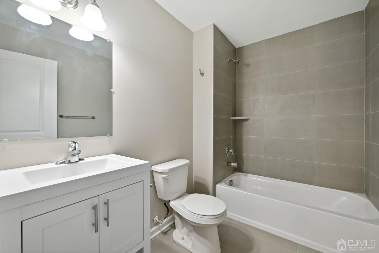 66 Runyon Avenue Edison, NJ 08817 - Photo 32 of 34 a bathroom with a sink toilet and shower