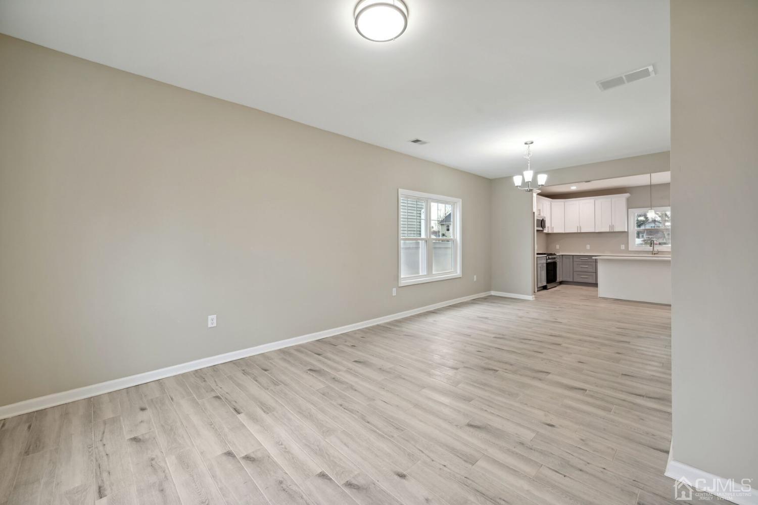 66 Runyon Avenue Edison, NJ 08817 - Photo 6 of 34 wooden floor in an empty room with a window