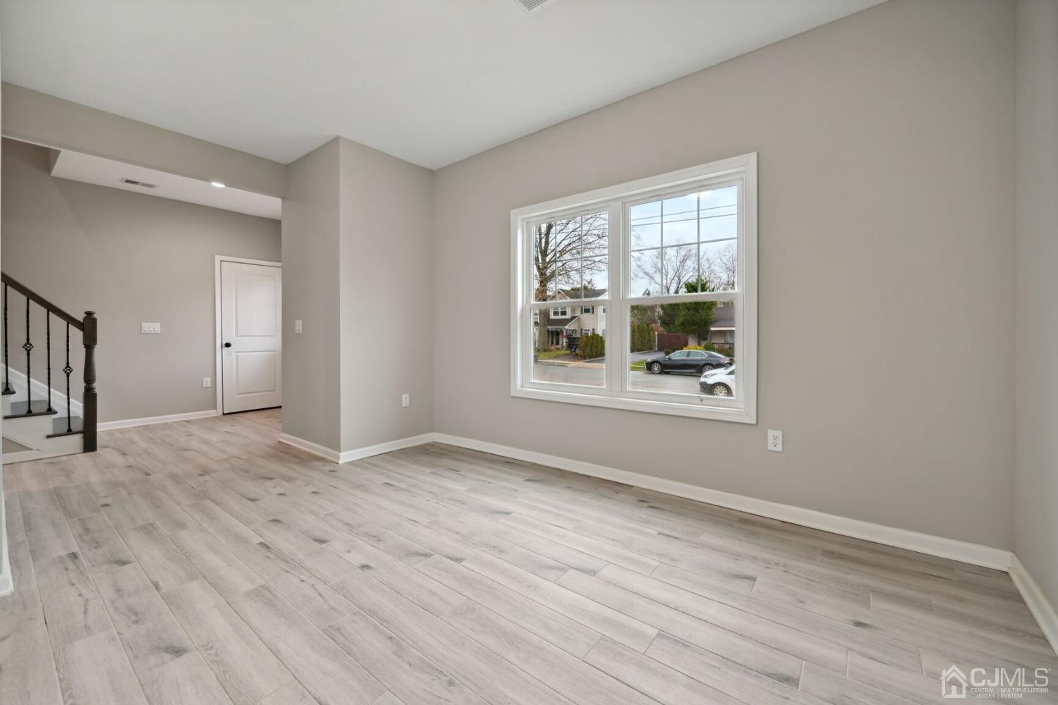 66 Runyon Avenue Edison, NJ 08817 - Photo 8 of 34 a view of an empty room with wooden floor and a window