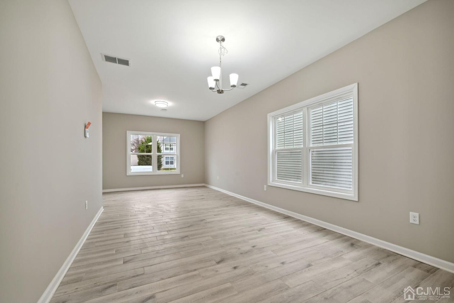 66 Runyon Avenue Edison, NJ 08817 - Photo 9 of 34 wooden floor in an empty room with a window