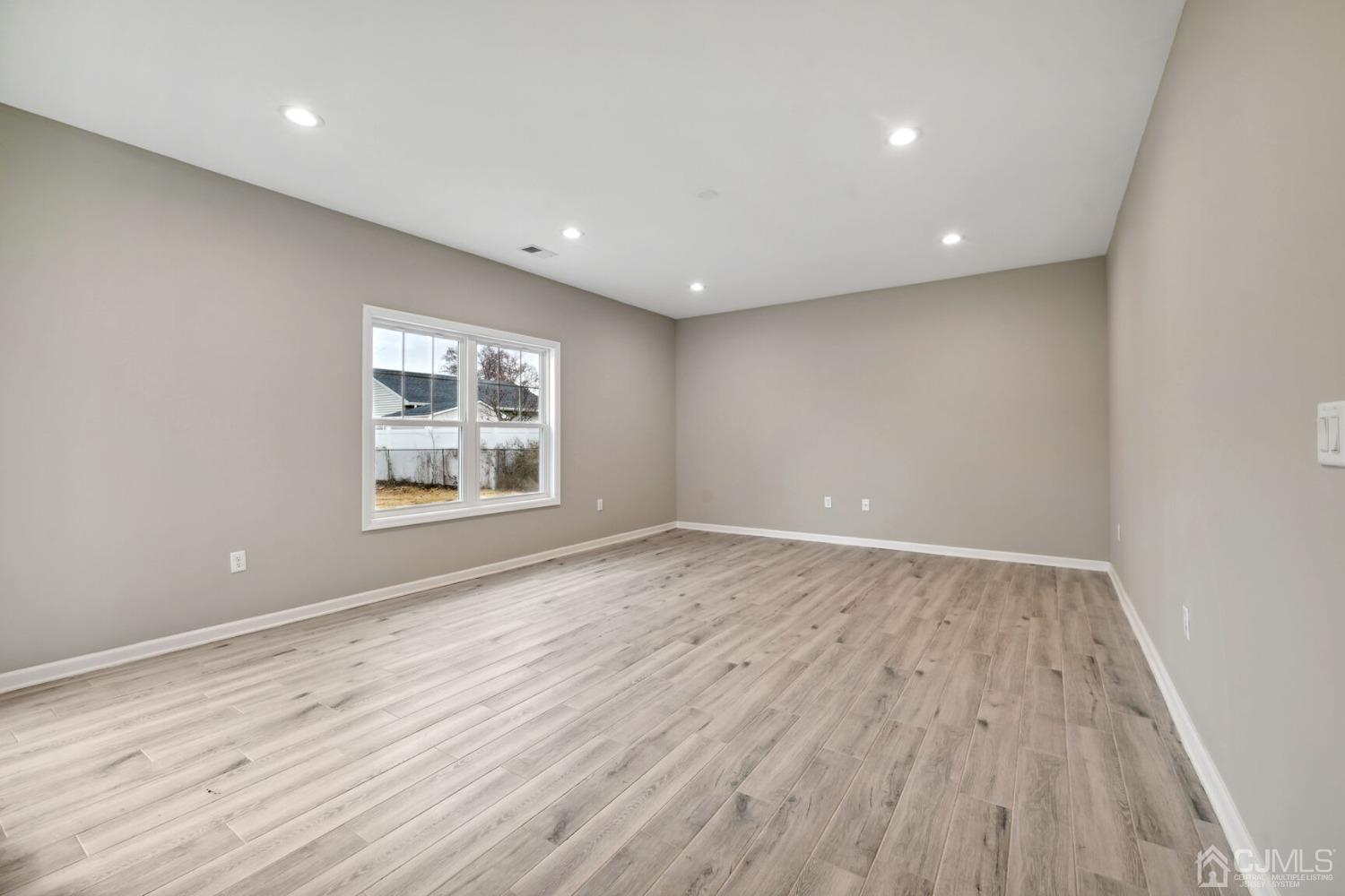 66 Runyon Avenue Edison, NJ 08817 - Photo 10 of 34 an empty room with wooden floor and windows