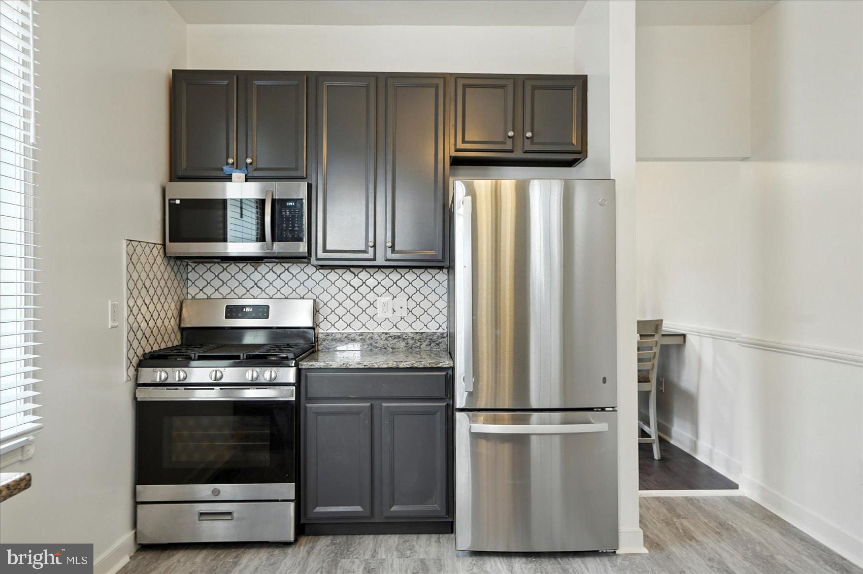 416 Mosher Street Baltimore, MD 21217 - Photo 11 of 38 a kitchen with a refrigerator stove and microwave