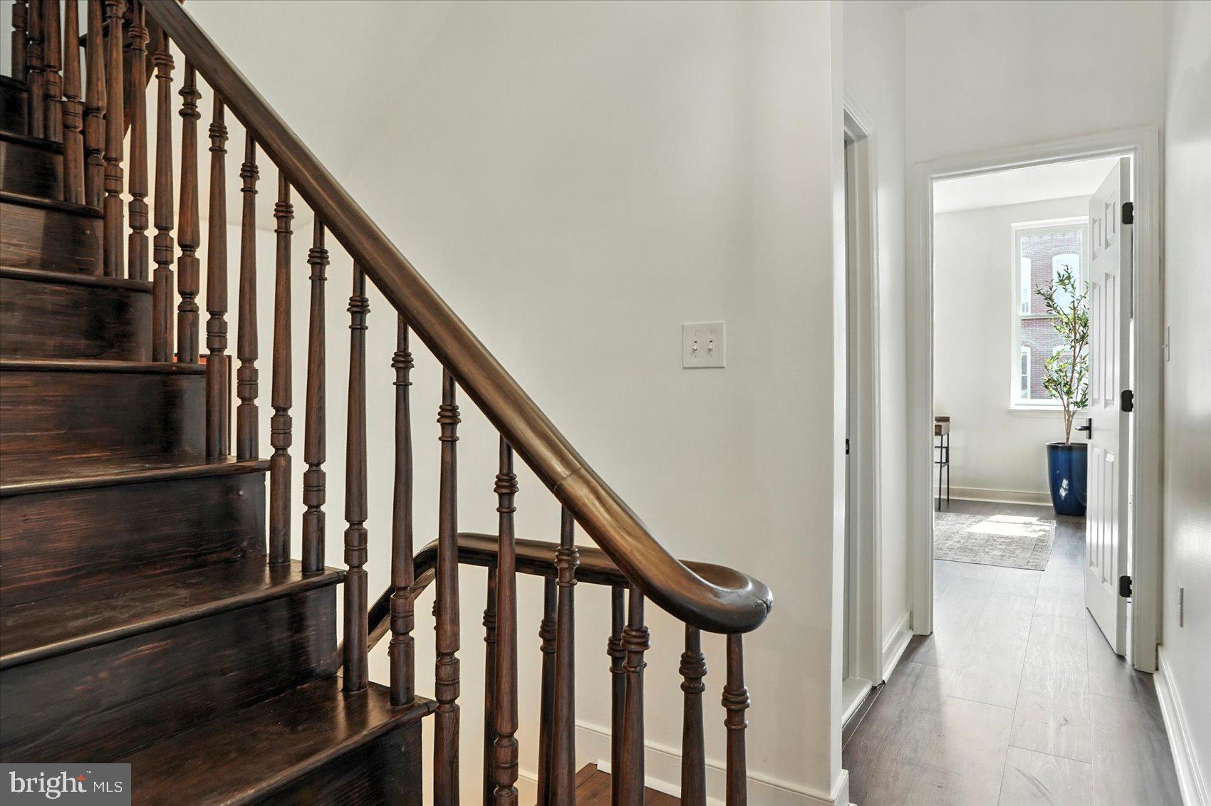 416 Mosher Street Baltimore, MD 21217 - Photo 27 of 38 a view of a hallway with wooden floor and stairs