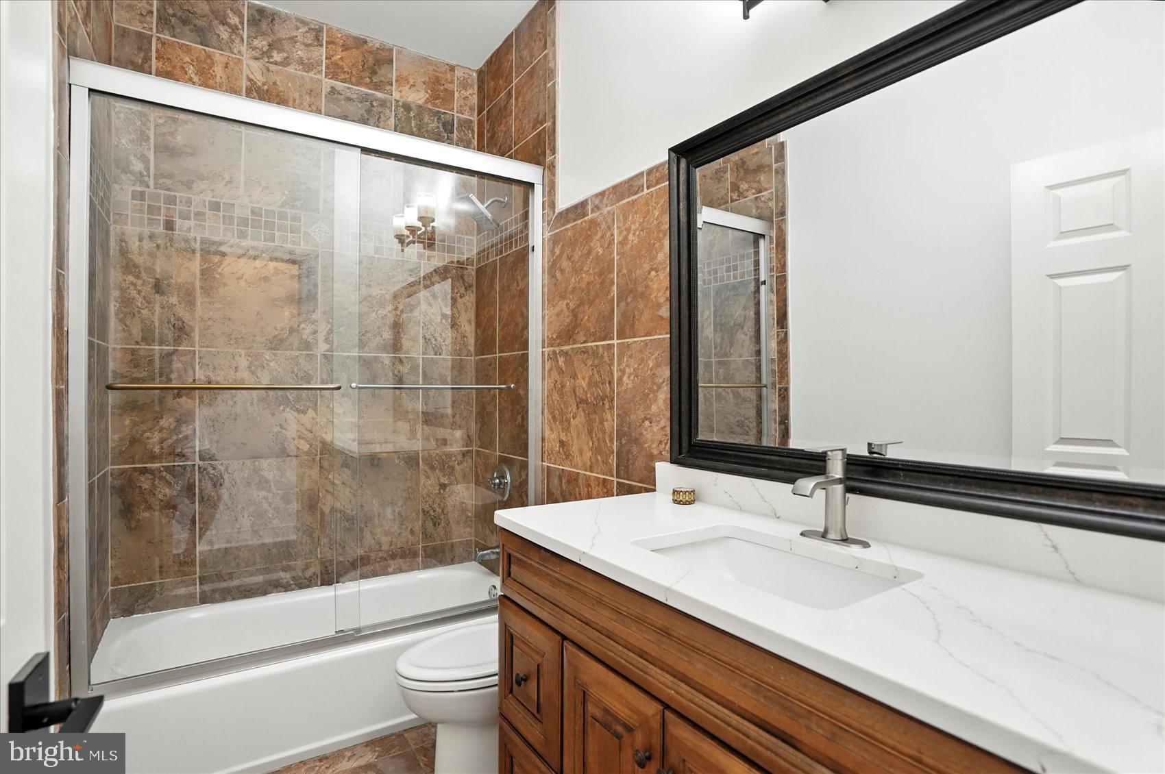 416 Mosher Street Baltimore, MD 21217 - Photo 33 of 38 a bathroom with a sink and a mirror