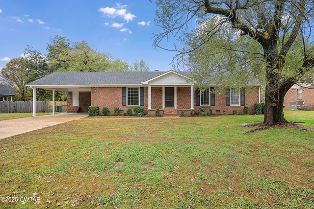 a front view of a house with a yard table and chairs