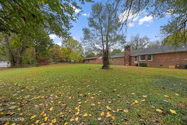 a view of house with garden space and trees