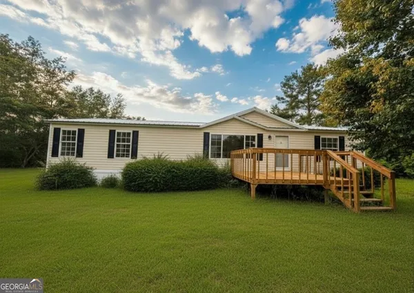 a view of a house with a backyard