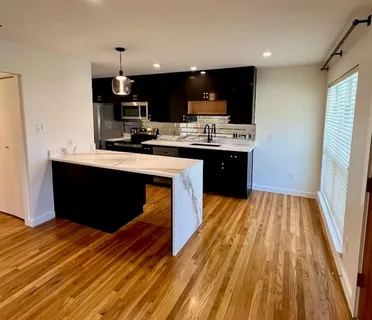 a kitchen with stainless steel appliances a sink dishwasher a stove and a refrigerator