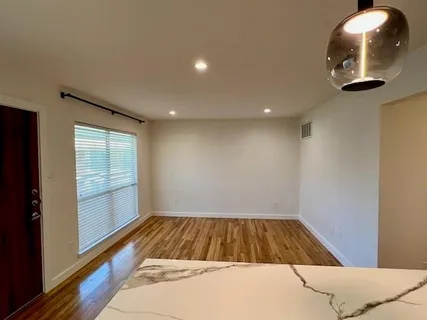 a view of a livingroom with furniture and wooden floor