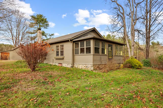 a big house with tall trees in front of it