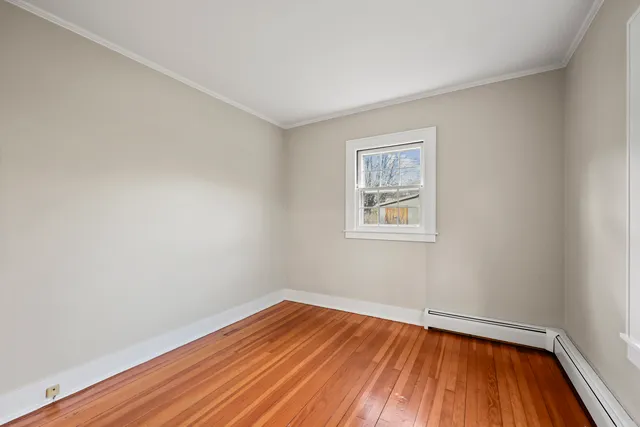 a view of room with wooden floor and window