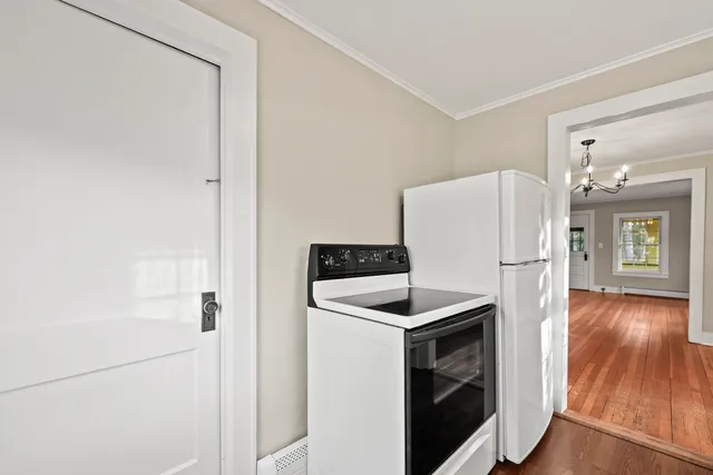 a kitchen with a refrigerator sink and wooden floor