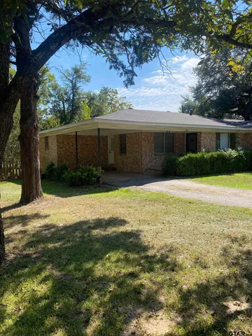 a backyard of a house with yard and outdoor seating
