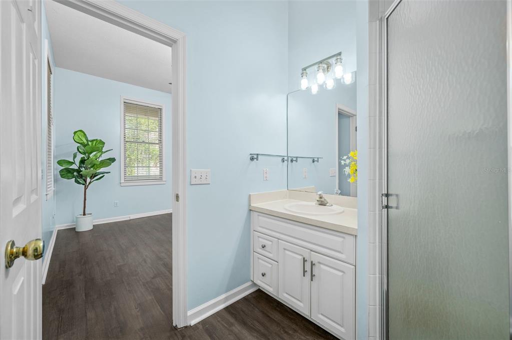 5213 Southwest 91 Terrace, Unit B Gainesville, FL 32608 - Photo 16 of 38 a bathroom with a sink a vanity and a mirror