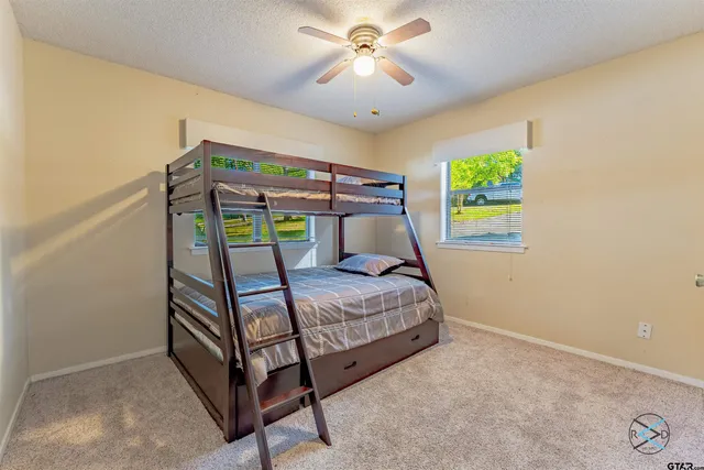 a bedroom with a bed and a ceiling fan