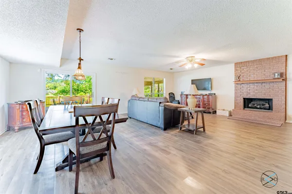 a view of a lake with a table and chairs under an umbrella