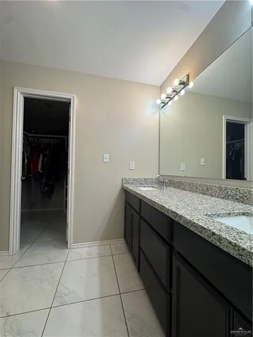 a large bathroom with a double vanity sink and a mirror