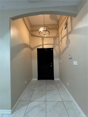 a view of a hallway with a chandelier