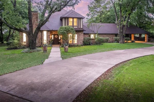 a front view of house with yard and green space